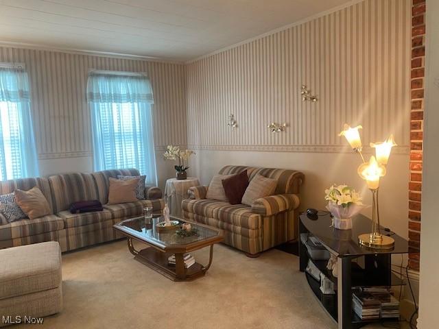 living room with a wealth of natural light, crown molding, and carpet