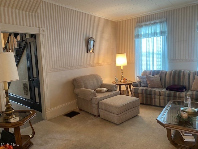 carpeted living room featuring crown molding