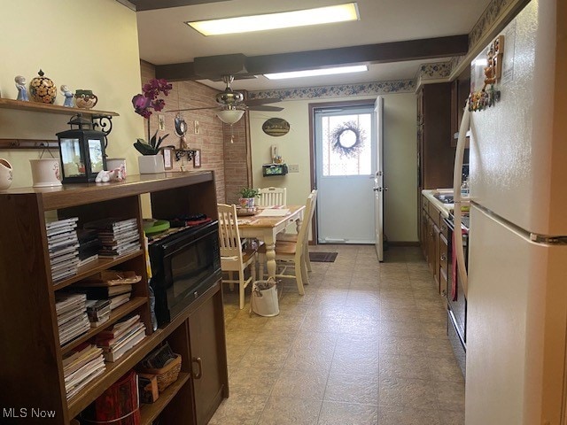 kitchen with ceiling fan, stainless steel range oven, and white fridge