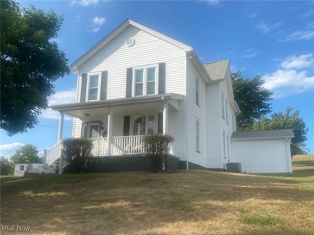 view of front of property with central air condition unit, a porch, and a front lawn