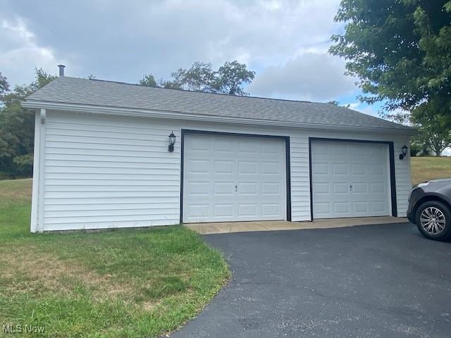 garage featuring a lawn