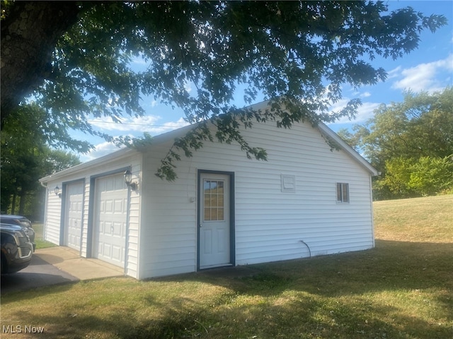 garage featuring a lawn