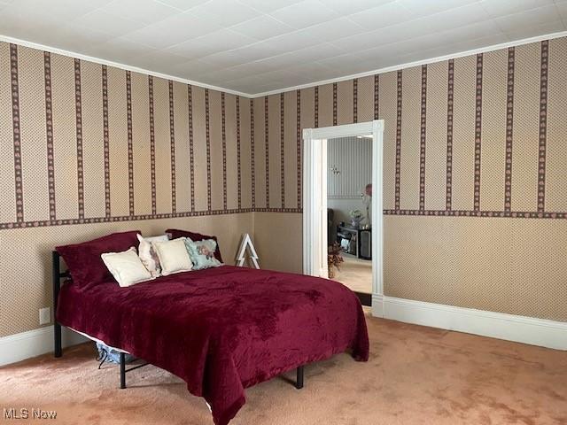 bedroom featuring ornamental molding and carpet flooring