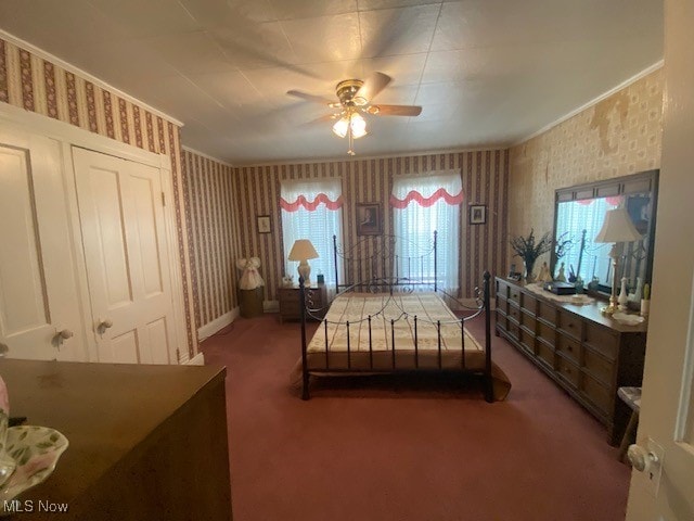 bedroom featuring multiple windows, ceiling fan, and carpet floors