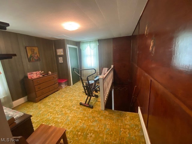 bedroom featuring wood walls