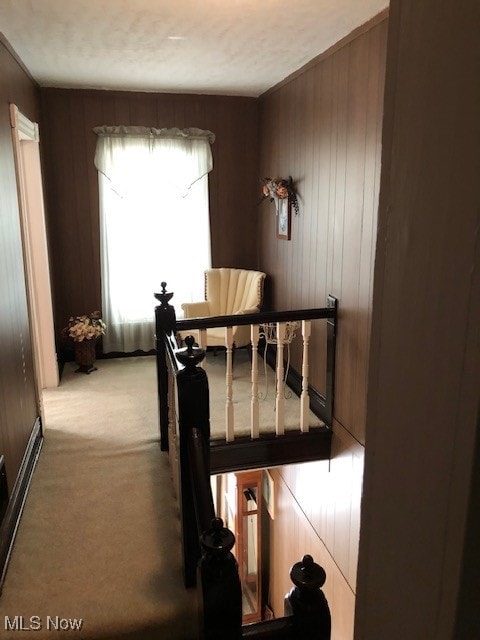 carpeted bedroom featuring wooden walls