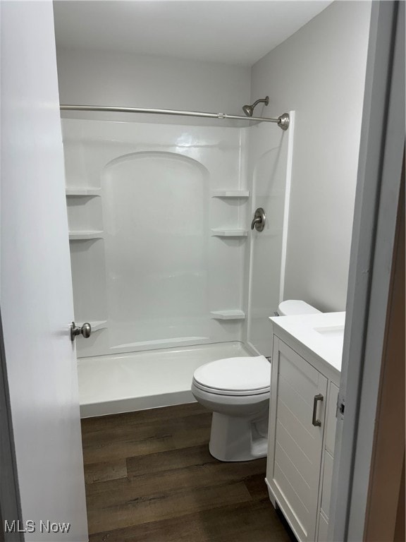 full bathroom with vanity, shower / bath combination, toilet, and hardwood / wood-style floors