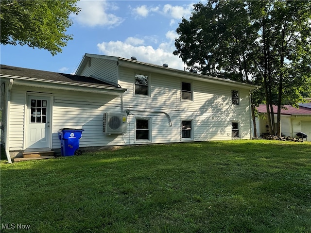 rear view of property featuring a lawn