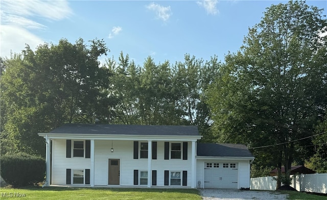 bi-level home featuring a garage and a front yard