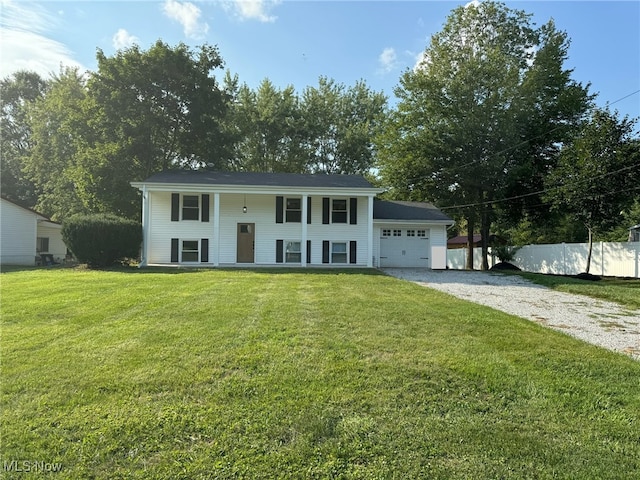 bi-level home featuring a garage and a front yard