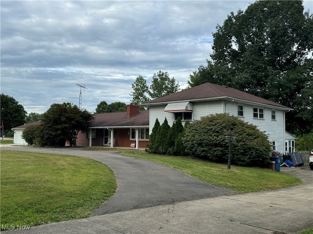 tri-level home with a front yard