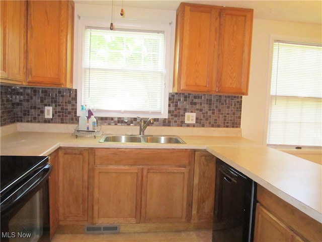 kitchen featuring sink, tasteful backsplash, and black appliances