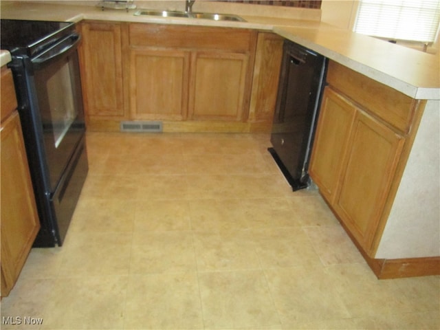 kitchen with black appliances, sink, and kitchen peninsula