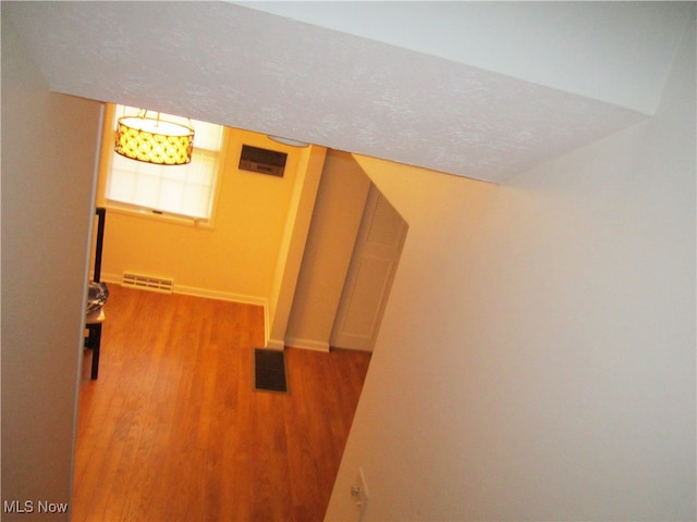 interior space featuring hardwood / wood-style flooring and a textured ceiling