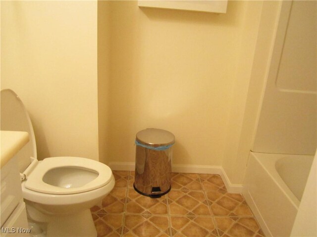 full bathroom featuring toilet, vanity, plus walk in shower, and tile patterned floors