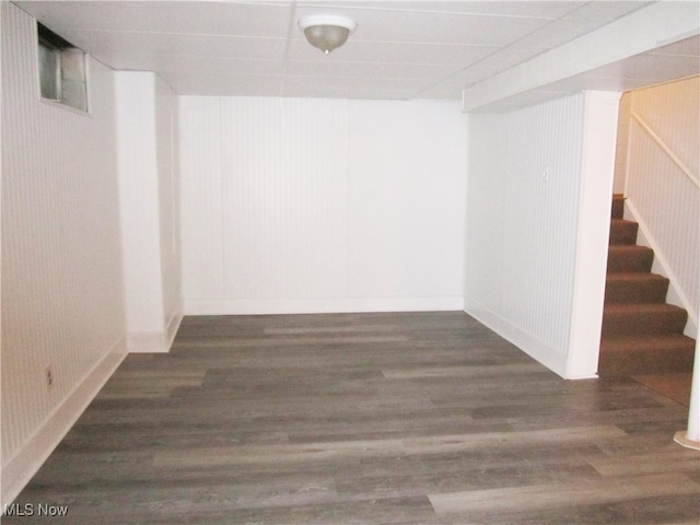 basement with dark hardwood / wood-style flooring