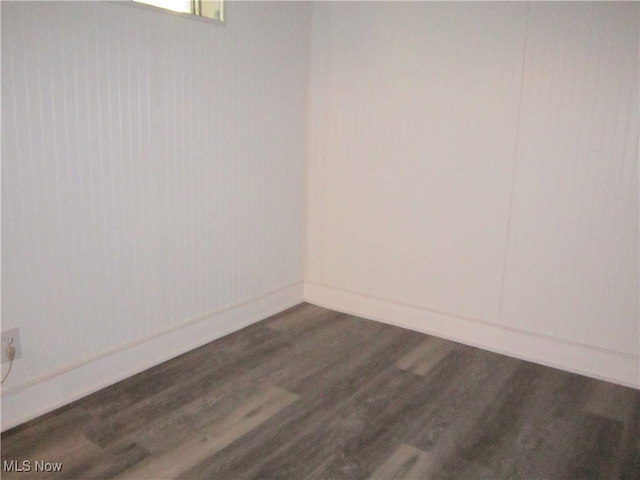 empty room with dark hardwood / wood-style floors