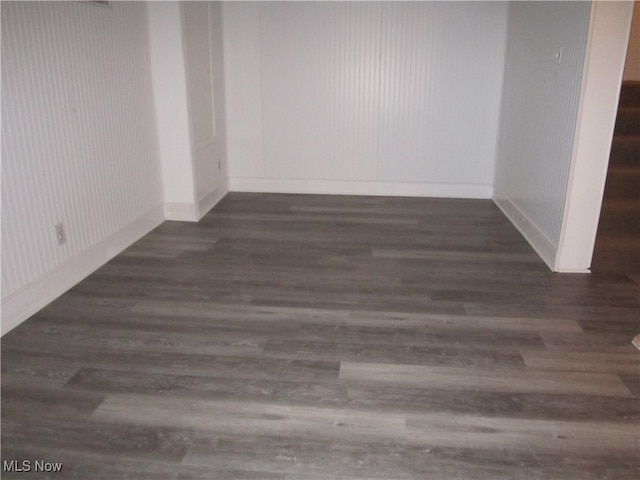 empty room with dark hardwood / wood-style floors