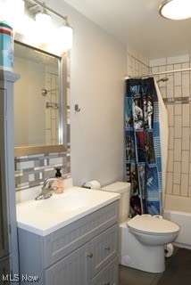 full bathroom with decorative backsplash, shower / bath combination with curtain, toilet, and vanity