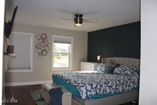 bedroom with ceiling fan and wood-type flooring