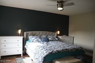 bedroom featuring dark hardwood / wood-style floors and ceiling fan