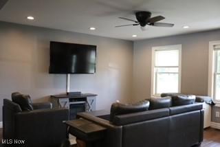 living room with ceiling fan and wood-type flooring