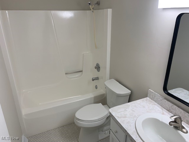 full bathroom with vanity, tile patterned flooring, bathing tub / shower combination, and toilet