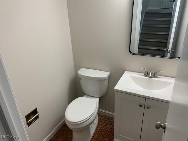 bathroom featuring tile patterned floors, vanity, and toilet