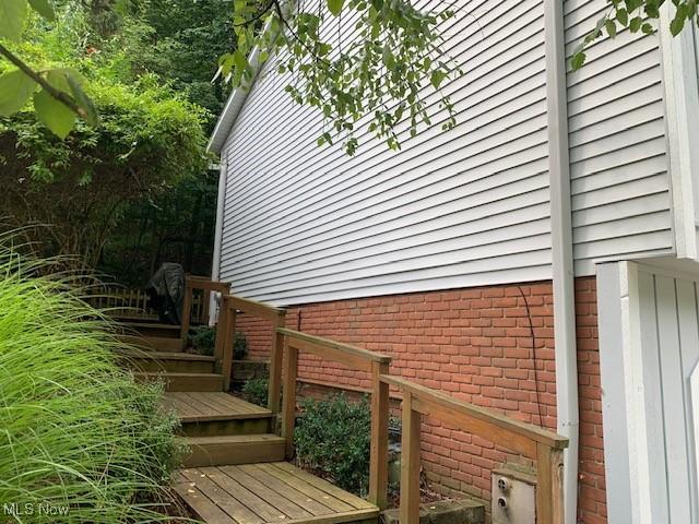 view of side of property featuring a wooden deck