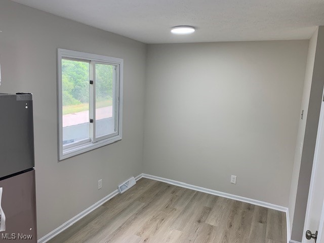 unfurnished dining area with light hardwood / wood-style flooring