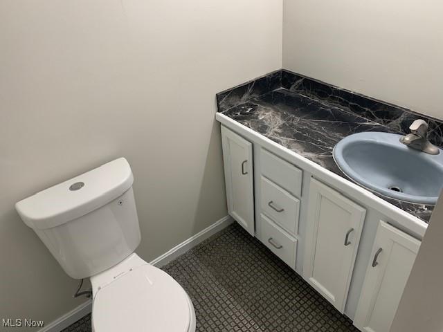 bathroom featuring vanity, toilet, and tile patterned flooring