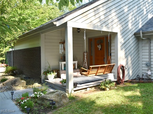 doorway to property featuring covered porch