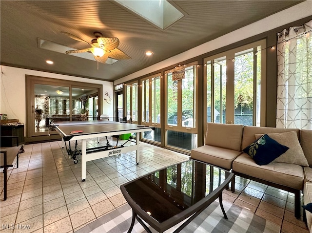 rec room with ceiling fan and light tile patterned flooring