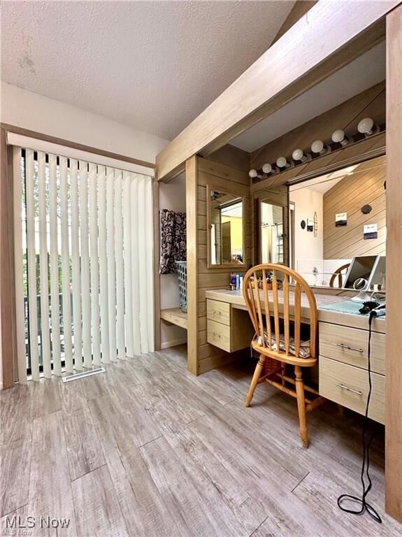 interior space featuring hardwood / wood-style flooring, a textured ceiling, and vanity