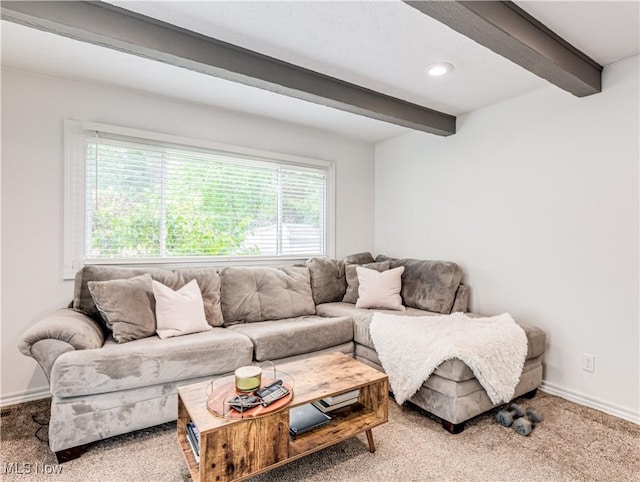 carpeted living room with beam ceiling and baseboards