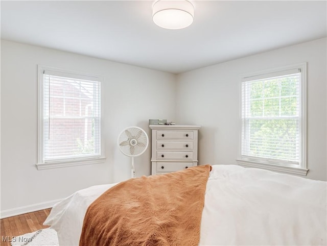 bedroom featuring wood finished floors and baseboards