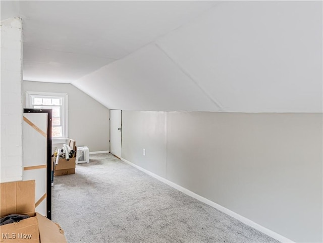 bonus room featuring carpet, baseboards, and vaulted ceiling