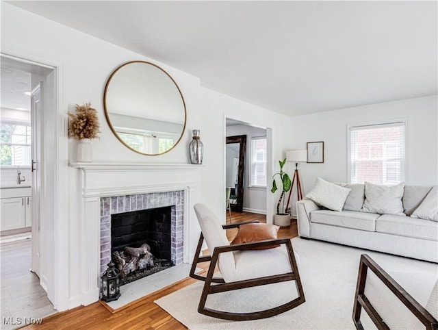 living area with a fireplace and light wood-style floors