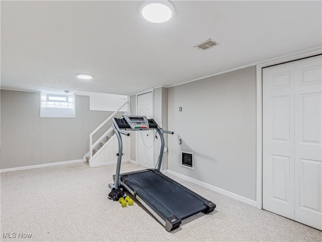 exercise room with carpet, visible vents, and baseboards