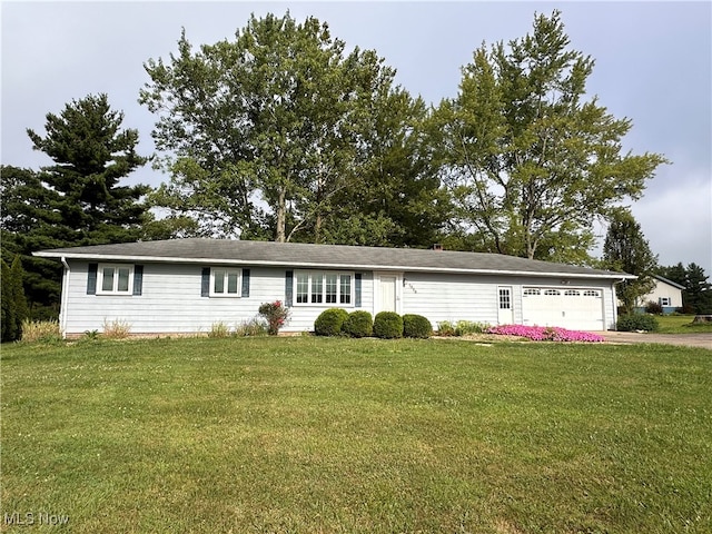 ranch-style home featuring a garage and a front lawn