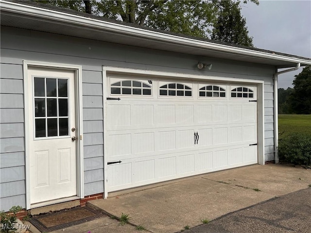 garage with concrete driveway