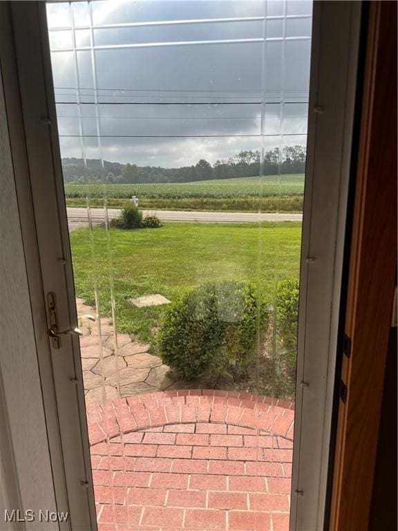 doorway to outside with a rural view