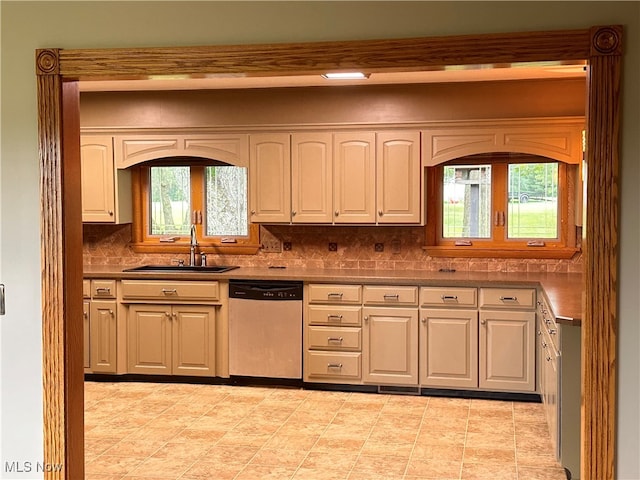 kitchen featuring light tile patterned flooring, dishwasher, tasteful backsplash, and sink