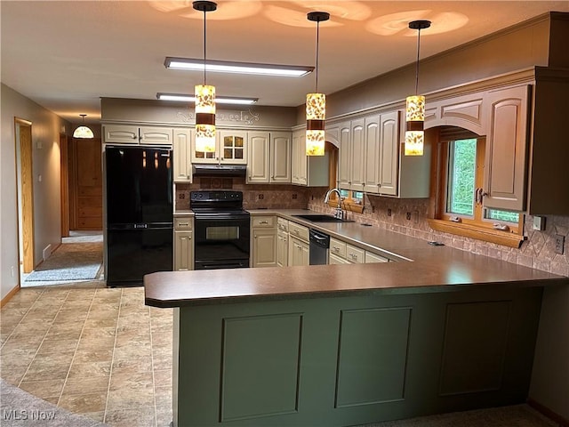 kitchen with under cabinet range hood, decorative backsplash, a peninsula, black appliances, and a sink