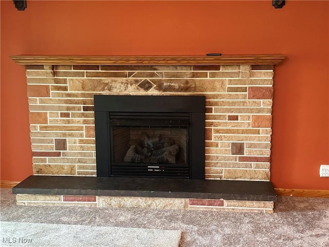 room details with carpet flooring and a fireplace