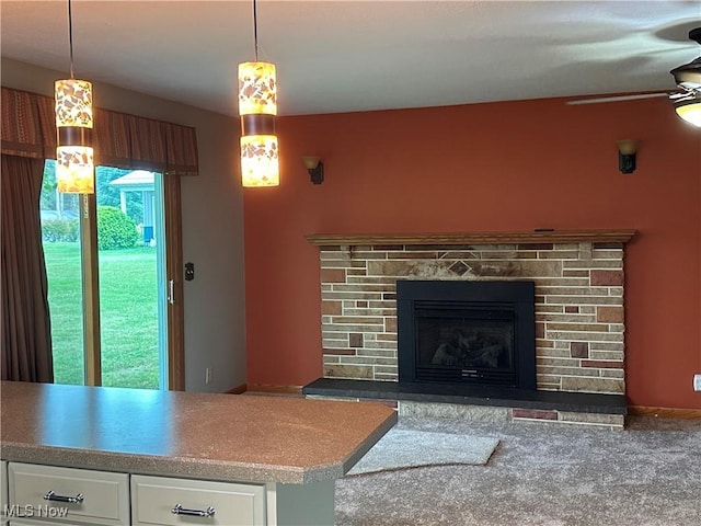 living room with a stone fireplace and a ceiling fan