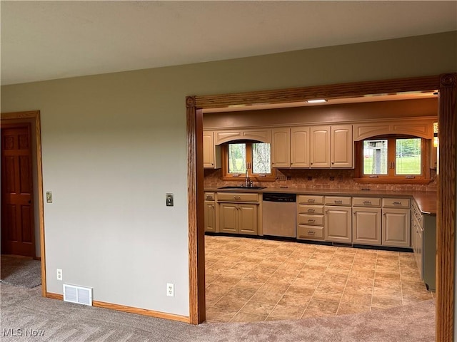 kitchen with a sink, visible vents, dishwasher, and a wealth of natural light