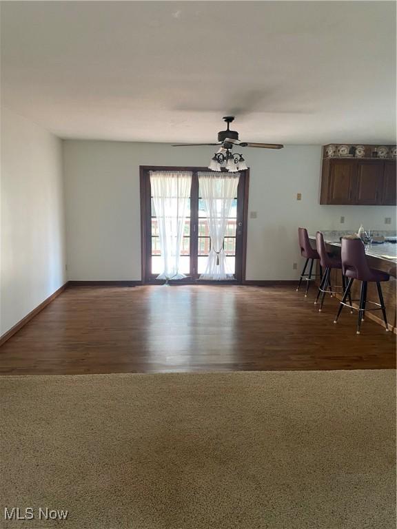 unfurnished dining area with ceiling fan and hardwood / wood-style floors