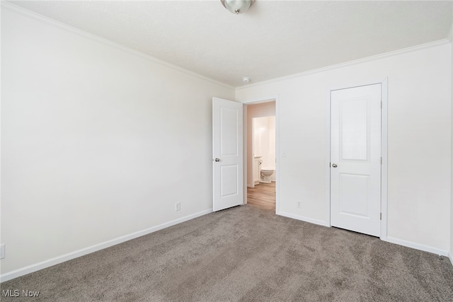 unfurnished bedroom featuring carpet floors and ornamental molding