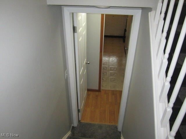 corridor with dark hardwood / wood-style flooring